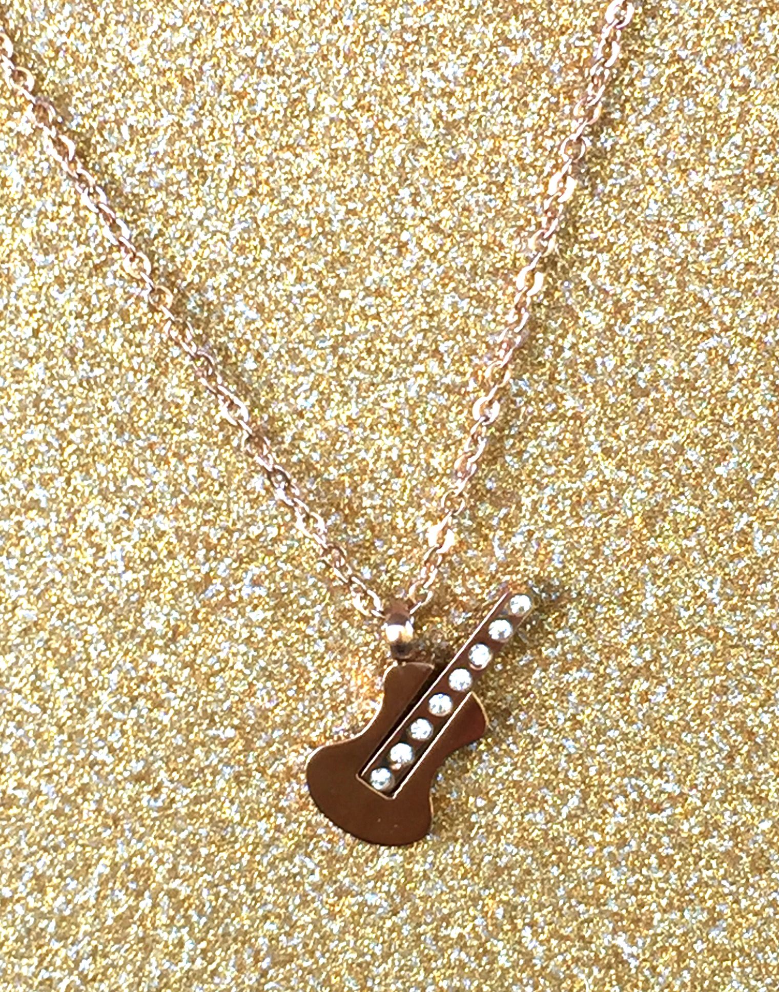 A beautiful butterfly pendant made of mother of pearl and emblazoned with small glittering crystals on a gold metal base. J020010